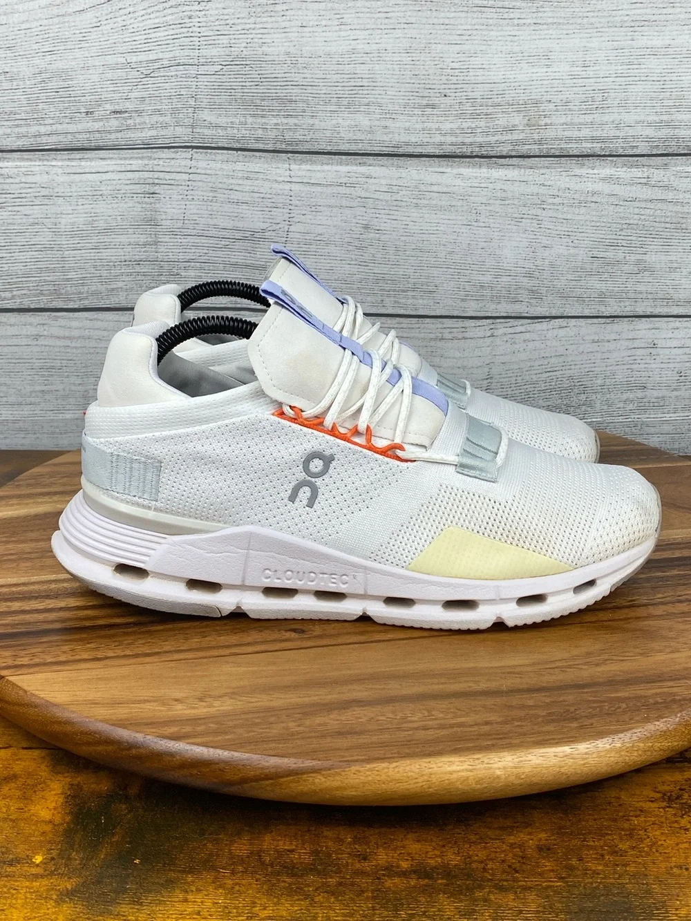 On Running White Athletic Sneakers with Light Purple and Orange Accents